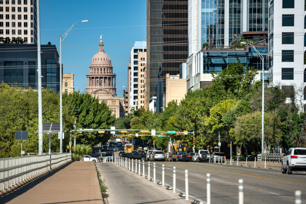 Austin Texas Congress Avenue by State Capitol with traffic and pedestrians